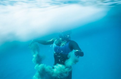A person diving in the blue water of Hawaii