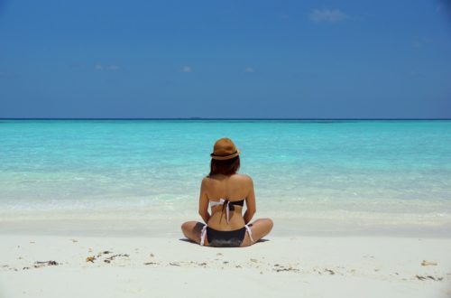 A woman meditating on a beach