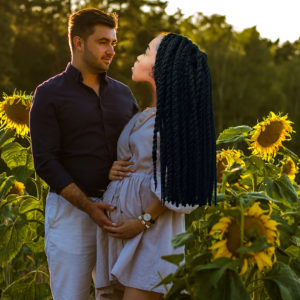 A white man with a black woman in a field of sunflowers