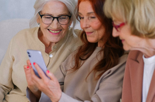 Three women performing a search on a mobile device.