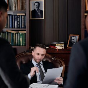 A lawyer in his office reading a contract.