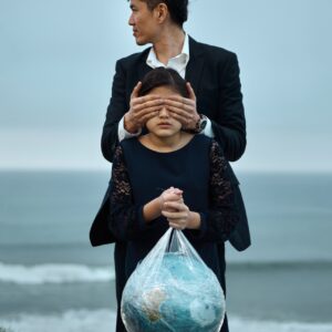 Man and Girl with globe in plastic bag.