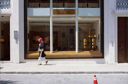 Image of a woman walking along a fashionable street