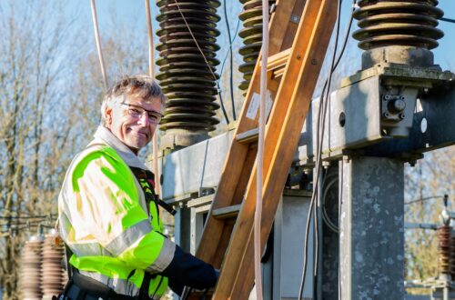 A happy man working on an electrical transformer