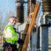 A happy man working on an electrical transformer