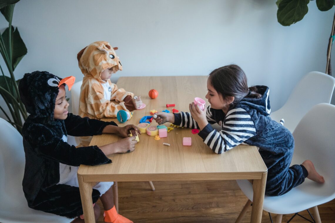 Toddlers wearing masks playing together.