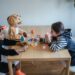 Toddlers wearing masks playing together.