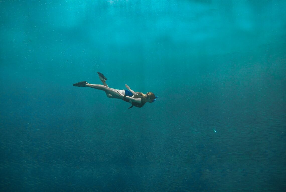 A diver in the vast pool of what seems like an endless sea.