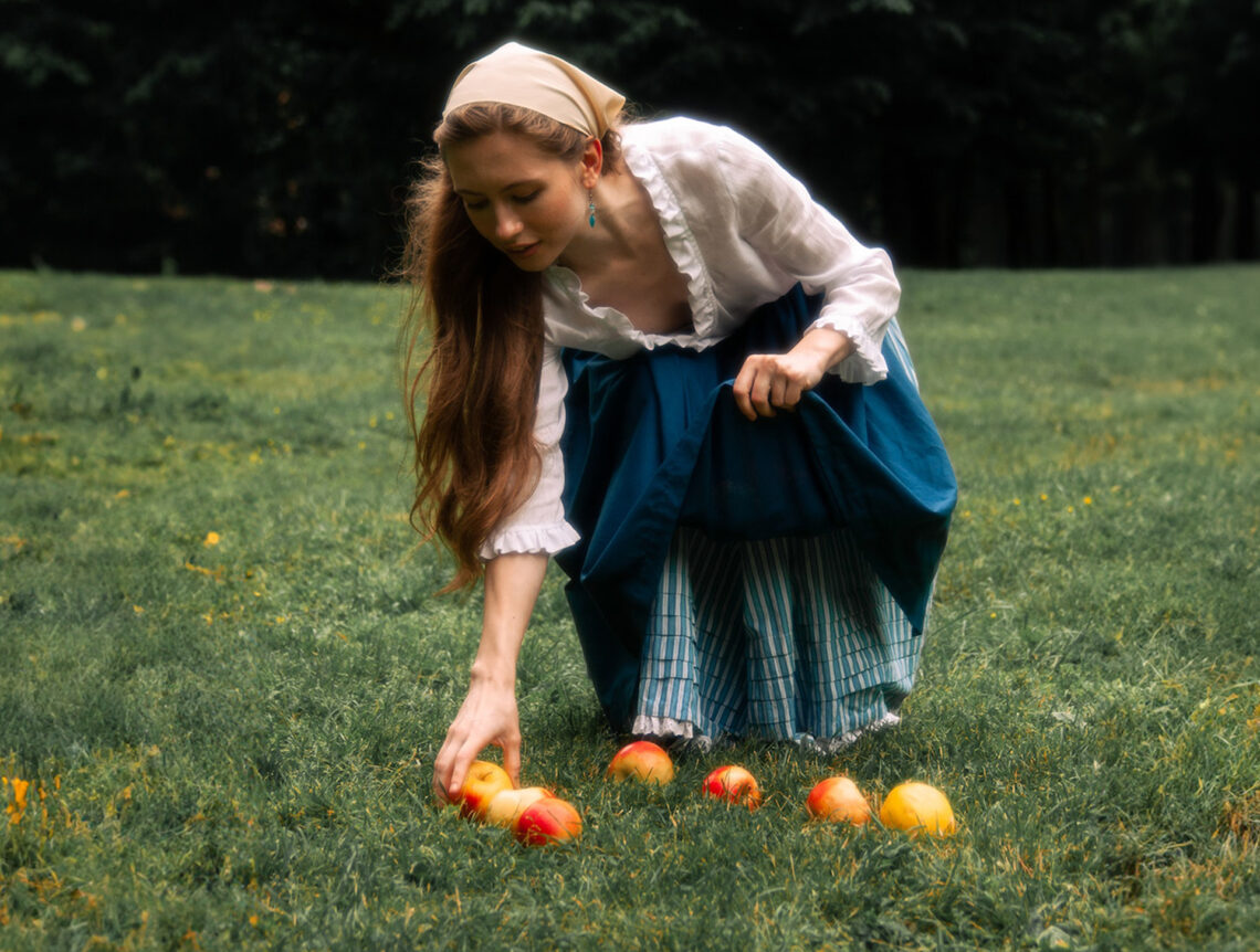 Someone picking up apples.