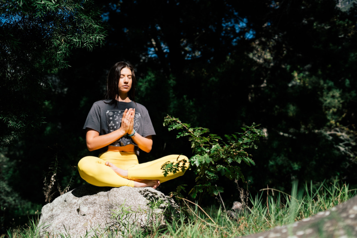 A young person meditating.