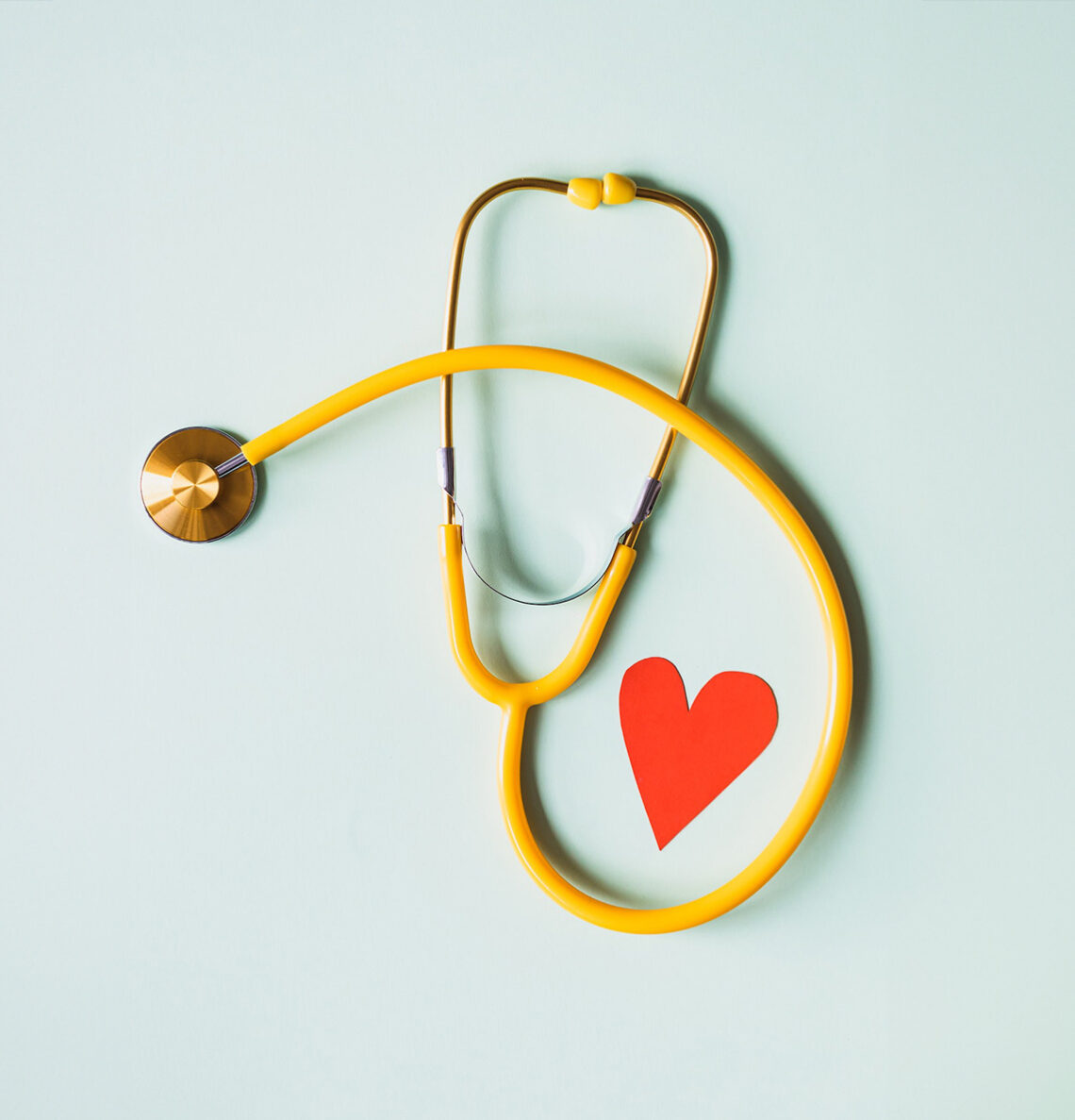 An artistic photograph of a stethoscope and a red heart
