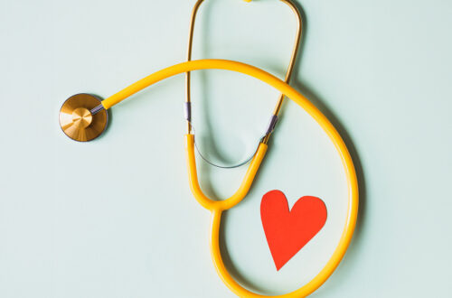 An artistic photograph of a stethoscope and a red heart