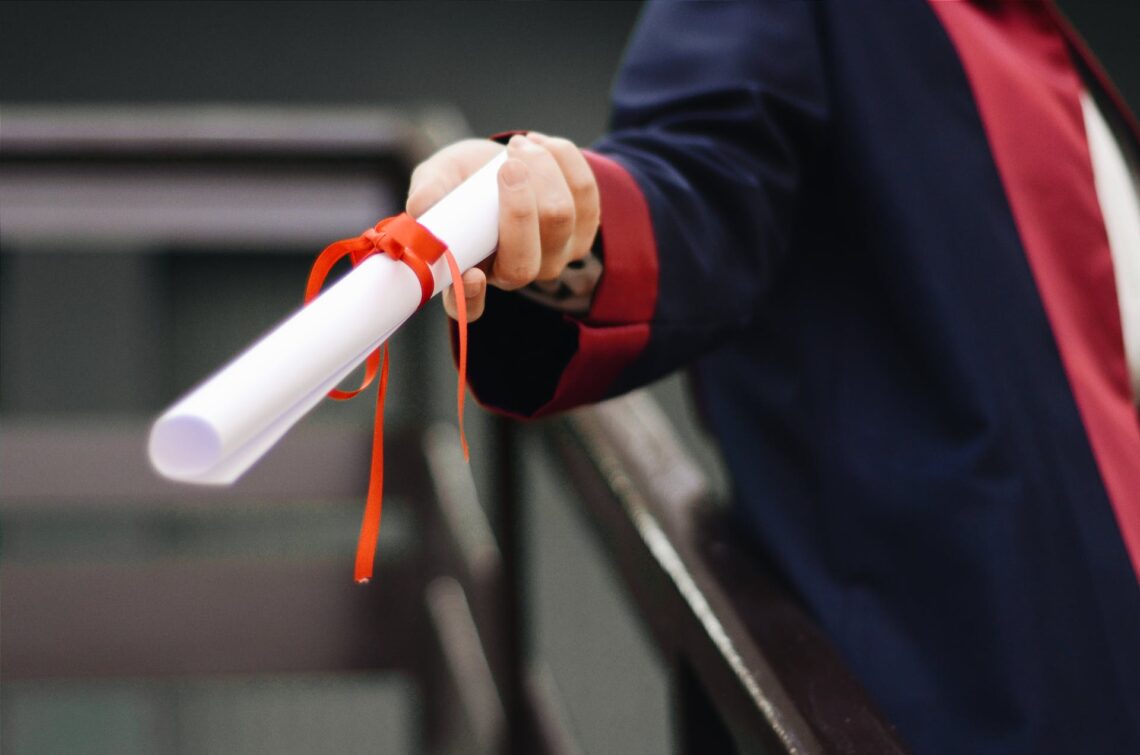 An arm holding a certificate