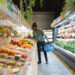 A man in a supermarket aisle.