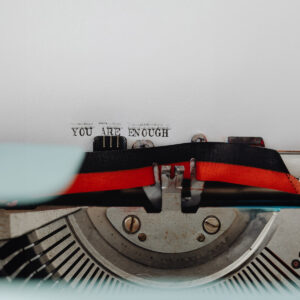 A typewriter that has written: 'You are enough'.