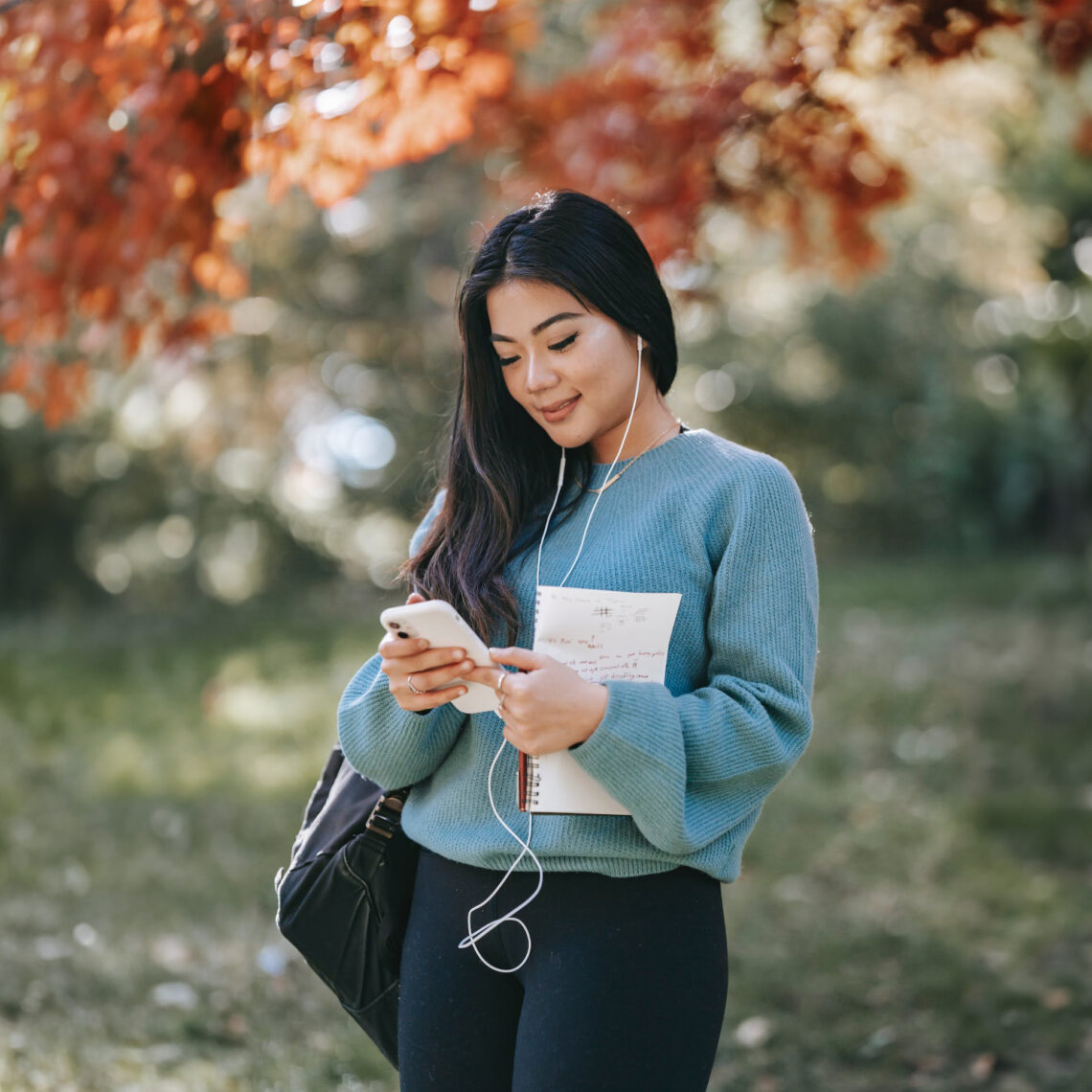 A woman in nature distracted by her smartphone